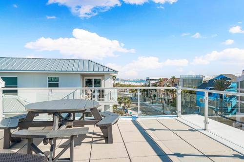 a patio with a picnic table on a balcony at Lookout in Siesta Key
