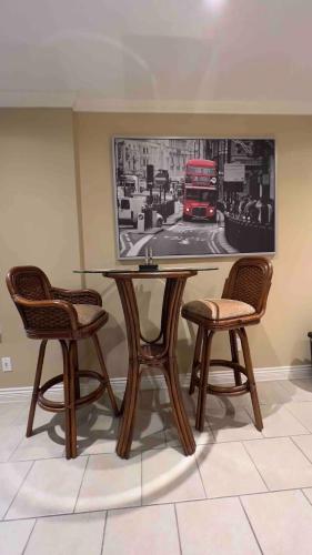 a table with two chairs and a picture of a bus at Spacious comfy stay in Richmond