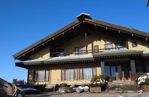 a yellow building with a balcony on top of it at Gold lich - Vacation STAY 18602 in Kamikawa