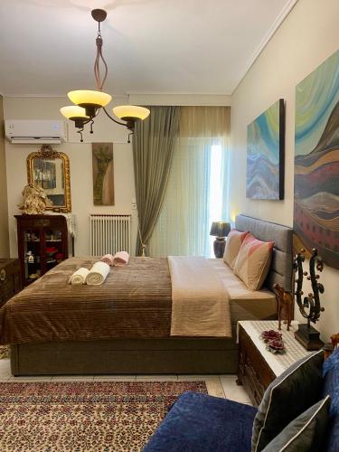 a bedroom with a large bed and a couch at top8 view in Tríkala