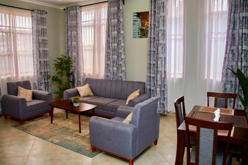 a living room with a couch and a table at Mvule Homes in Arusha