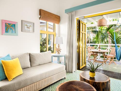 a living room with a couch and a table at Boardwalk Boutique Hotel Aruba - Adults Only in Palm-Eagle Beach