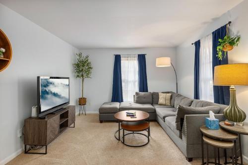 a living room with a couch and a tv at New! Special Rate for First Bookings! 2 Bedroom in Charlotte