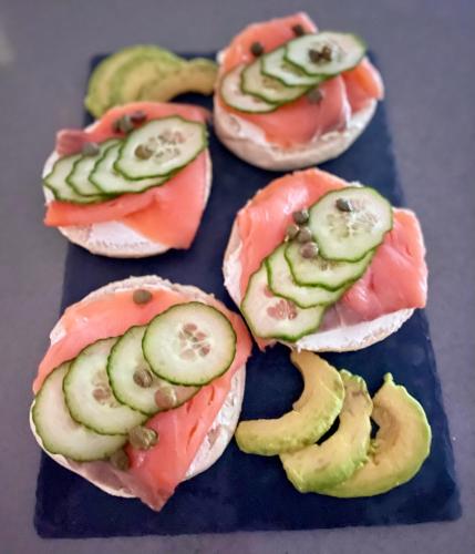 a group of sandwiches with cucumbers and tomatoes on them at HARITZAGA chambre d'hôte terrasse & jardin privé in Biarritz