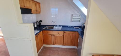 a small kitchen with a sink and a staircase at Hotel del Volcán in Pucón