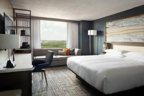 a hotel room with a bed and a couch at Marriott Jacksonville in Jacksonville