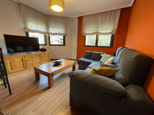 a living room with a couch and a table at Moradas Portilla in Portilla de la Reina