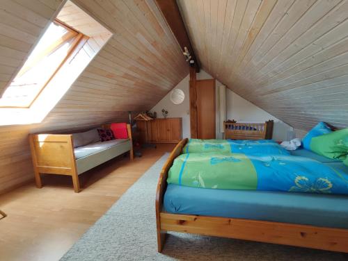 a attic bedroom with a bed and a window at Große, gemütliche Wohnung in dörflicher Idylle in Breitenbach am Herzberg
