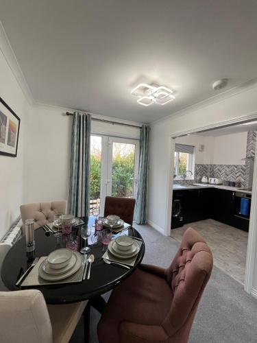 a living room with a dining room table and chairs at Stylish Highland Home in Fort William