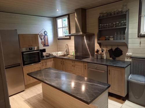 une grande cuisine avec un comptoir et une cuisinière dans l'établissement Ferme 16 pers Calme et Nature à Clécy, à Clécy