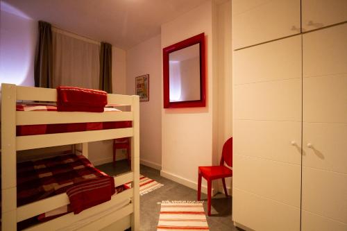 a bedroom with two bunk beds and a red chair at City 60 in Verviers