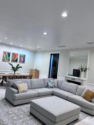 a living room with a couch and a table at Manna Villa - Sovereign Palms CI in Arorangi