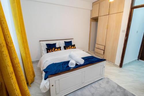 a bedroom with a bed with two towels on it at Charme Nest in Nanyuki