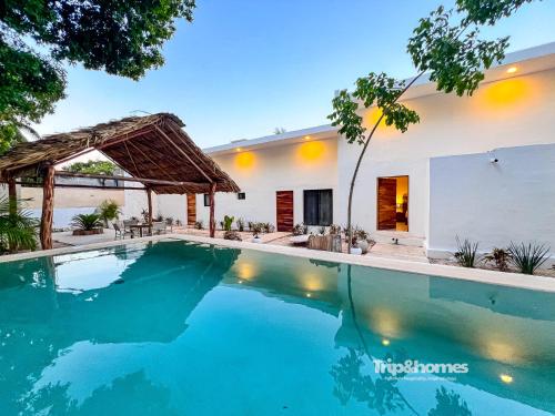 a swimming pool in front of a house at Depa Nacom in Valladolid
