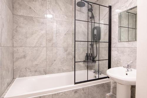 a bathroom with a shower and a sink at Manchester City Haven in Manchester
