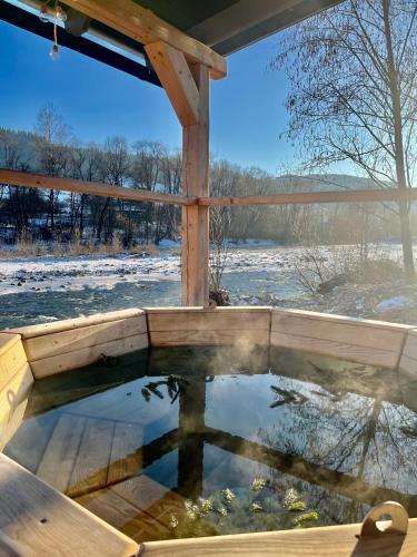 a pool of water in a wooden deck with snow at Shum Cheremosha in Verkhovyna