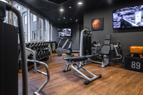 a gym with two treadmills and two tread machines at pentahotel Leuven in Leuven