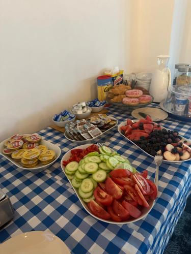 a blue and white table with plates of food at Apartmány Tri sestry Jasná in Demanovska Dolina