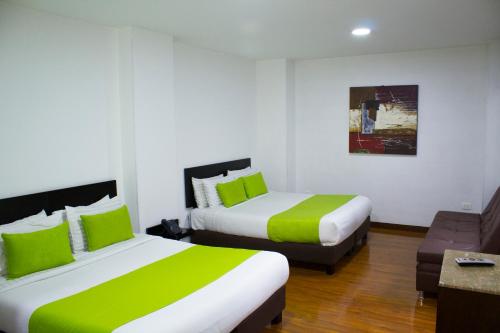 Postel nebo postele na pokoji v ubytování Hotel macao colombia