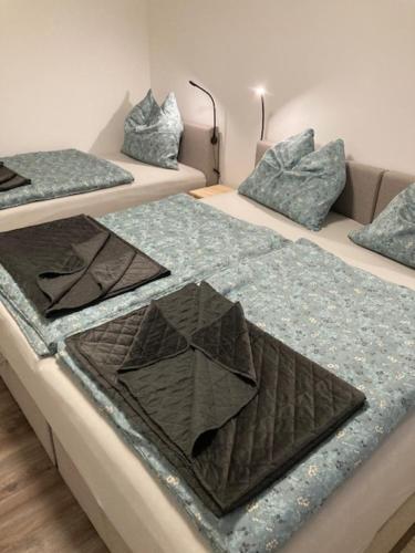 a group of three beds in a room at Apartman Liezen in Liezen