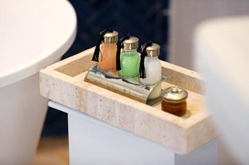 a tray with four bottles on a table at Riad Anyssates in Marrakech