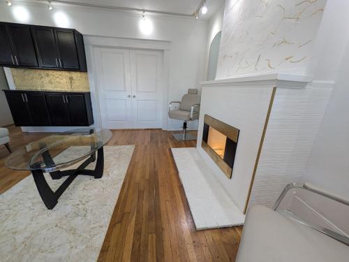 a living room with a fireplace and a glass table at Juliana Spa Suite - Entire Main Apartment in Winchester