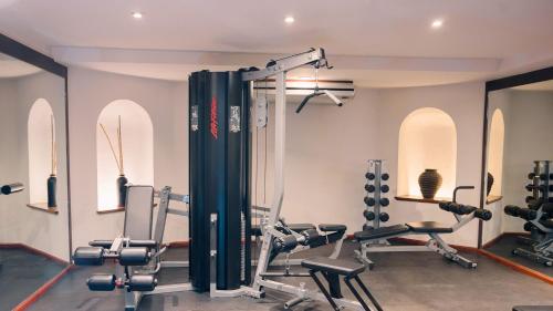 a gym with treadmills and machines in a room at Quinta Real Zacatecas in Zacatecas