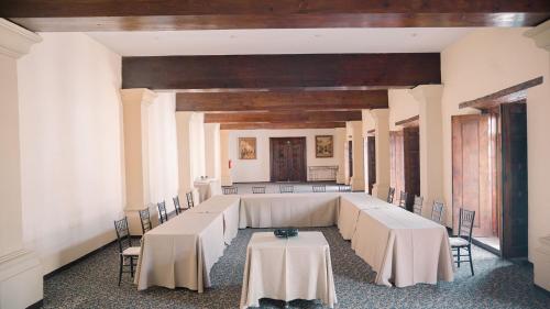 a room with tables and chairs in a building at Quinta Real Zacatecas in Zacatecas