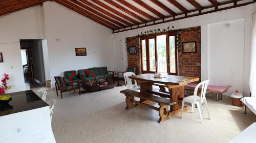 ein Wohnzimmer mit einem Holztisch und Stühlen in der Unterkunft Casa Linda in Villa de Leyva