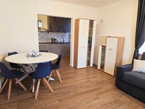a living room with a table and chairs and a couch at Casetta sui Monti - Alpine Stay Apartments in Tesero