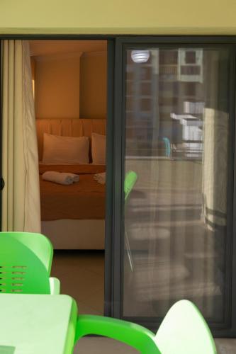a room with a bed and a sliding glass door at Vila Emi Apartment's in Durrës