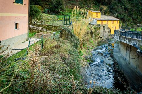 a small stream of water next to a building at L'Oliveto dei Cinque Sensi in Vernazza
