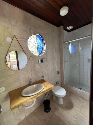a bathroom with a sink and a toilet and a shower at Recanto dos Vianas in Teresópolis