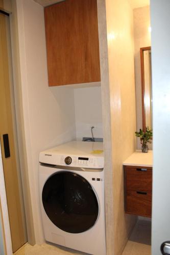 a kitchen with a washing machine in the corner at MAYAPAN Mérida HiSTORIC CENTER in Mérida