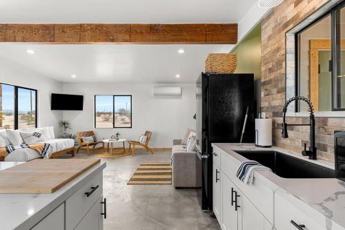 a kitchen with a sink and a living room at Charming Hoover Hideaway - Studio - A Location in Joshua Tree