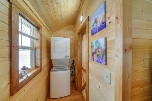 a bathroom with a washer and dryer in a wooden wall at 28 Mi to Downtown Louisville Serene Farm Getaway in La Grange