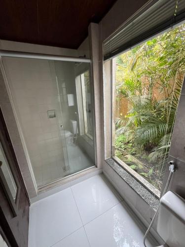a bathroom with a large window and a shower at Recanto dos Vianas in Teresópolis
