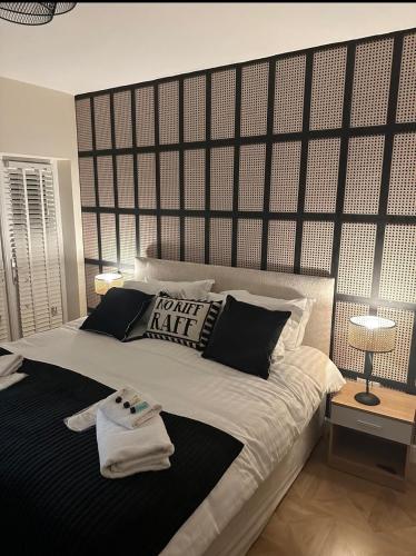 a bedroom with a large bed with a large headboard at The Mayfair Lodge & Family Suite in Hartlepool