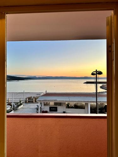 a view of the ocean from a window at Approdo Apartments in Isola Rossa