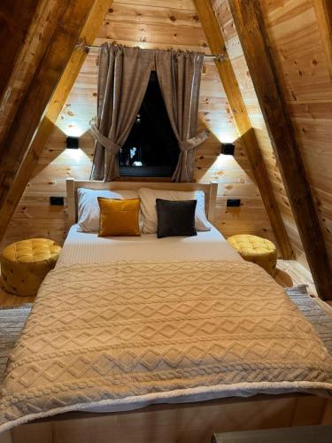 a bedroom with a large bed in a attic at Villas Sunny Hill in Žabljak