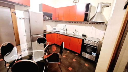 a kitchen with red cabinets and a stainless steel appliances at Muresenilor 16 Residence in Braşov