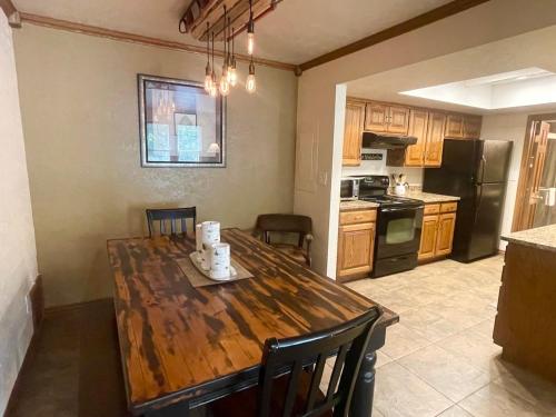a kitchen with a wooden table with chairs and a dining room at Snowed Inn in Brian Head