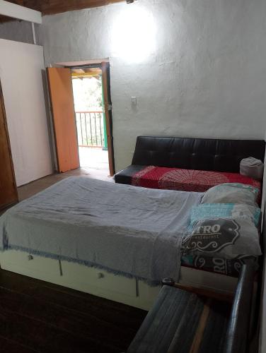a bedroom with a bed in a room with a window at Habitación en casa de campo via al aeropuerto in Copacabana