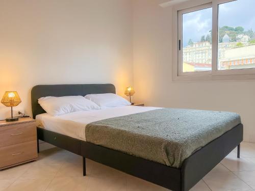 une chambre avec un grand lit avec une fenêtre dans l'établissement 2 pièces - 4 personnes - Entièrement équipé et idéalement situé proche toutes commodités, à Menton