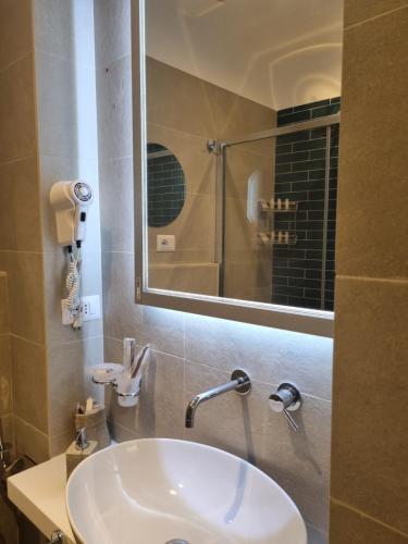 a bathroom with a sink and a mirror at B&B Naiadi Anzio in Anzio