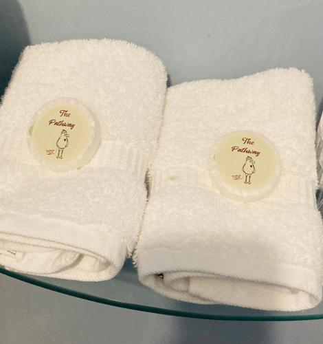 two towels sitting on top of a plate at The Pathway Guesthouse in Whitby