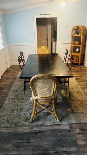 a dining room with a black table and chairs at Ocean Pearl Villa in Oak Island