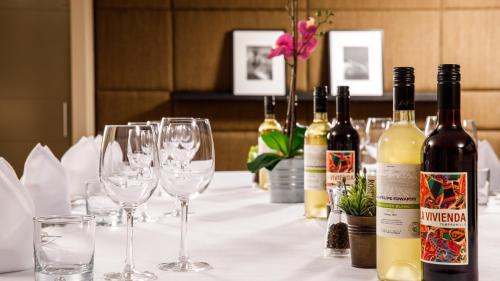 a table with wine bottles and glasses on it at Crowne Plaza Manchester Airport by IHG in Hale