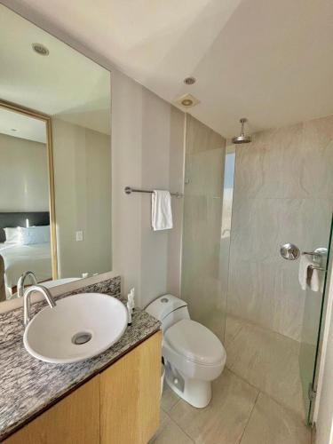 a bathroom with a toilet and a sink and a shower at Park Life Guadalajara in Guadalajara