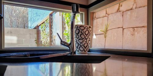 a mug sitting on a counter next to a window at Chic Townhome Retreat nestled Downtown in Albuquerque